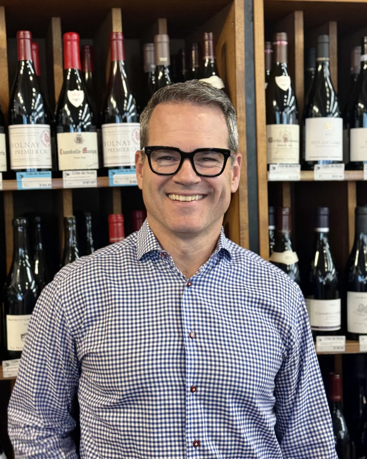 Brett Zimmerman, Master Sommelier, in front of the Burgundy shelves at Boulder Wine Merchant