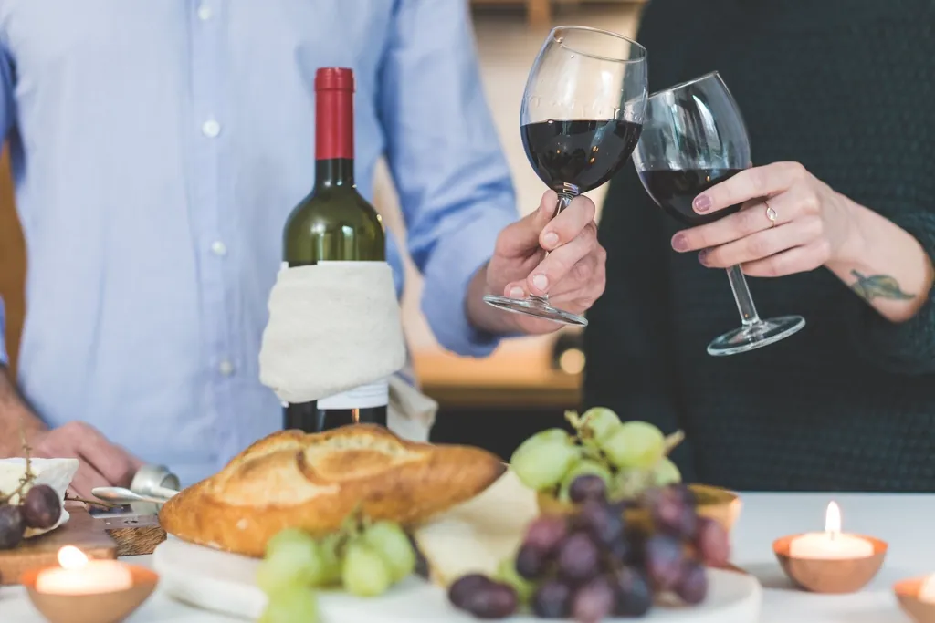 Couple toasting glasses red wine
