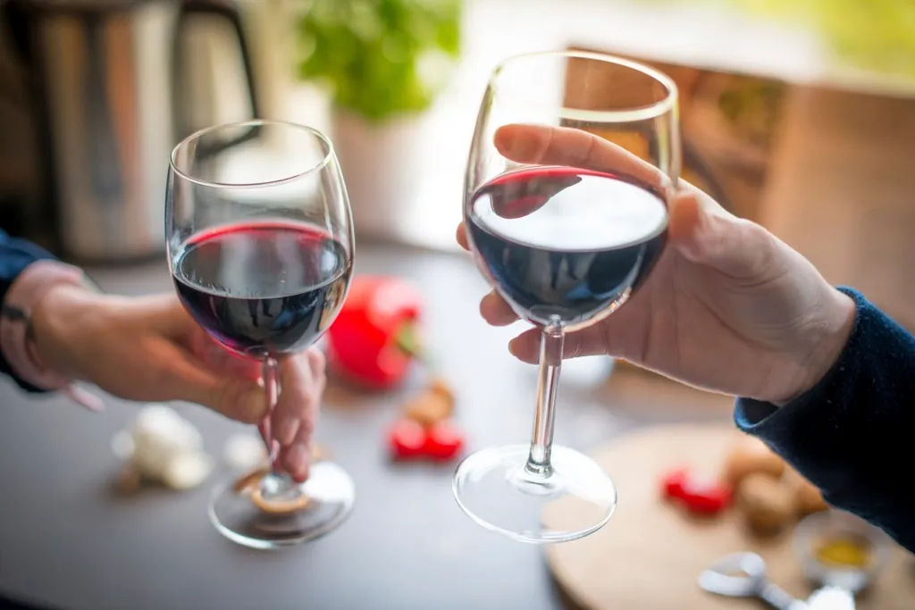 Holding red wine glass image