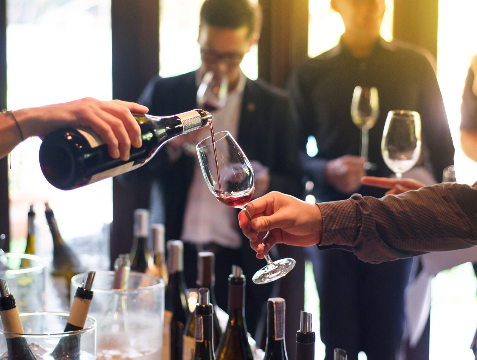 Wine tasting at Boulder Wine Merchant — pour into stem glass with sunset light